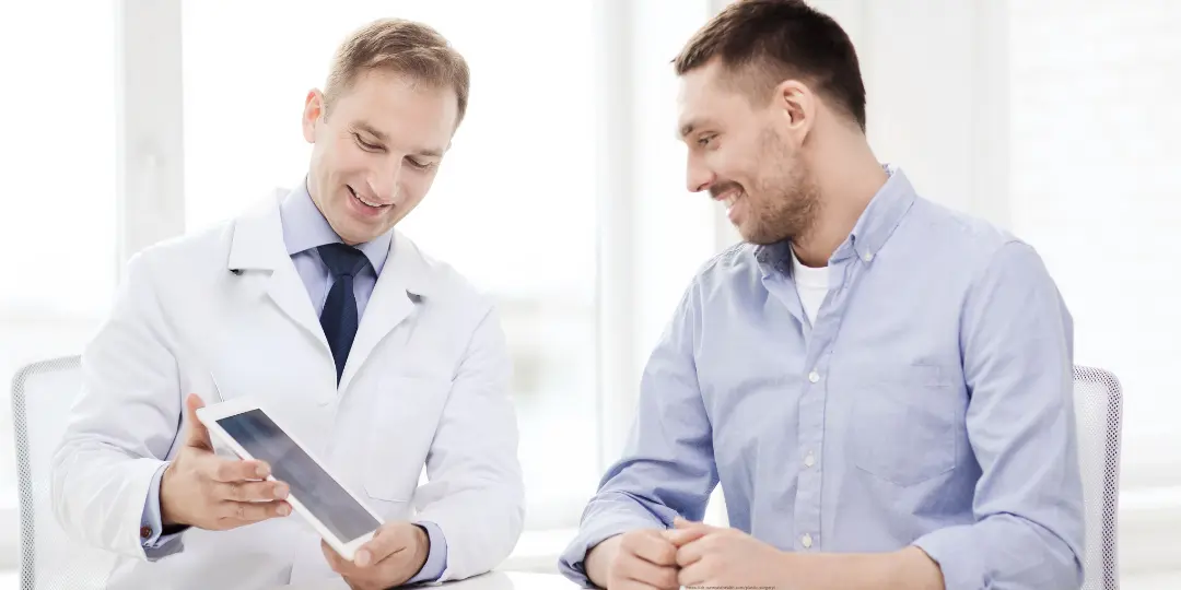 Doctor demonstrating CureCast clinical photo management app to a patient